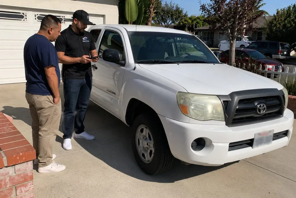 Local Sell My Car SoCal truck buyer reviewing a pickup truck with the seller at their Southern California home.
